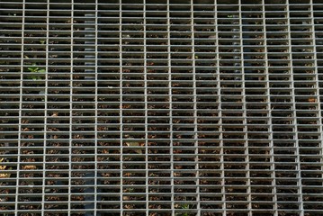 gray metal texture from old dirty iron grate on the street