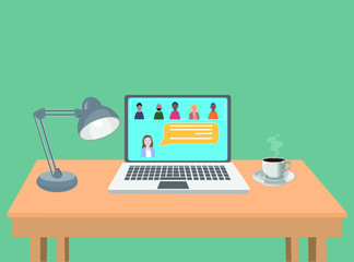 Laptop with a group of people in video conference . Meeting for work job or social meeting. Laptop over a wood table with a lamp and a cup of coffee.
