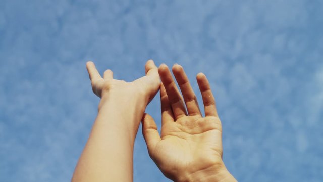 Close up on woman hands lift up to cloudy sky in early morning on the sunrise.