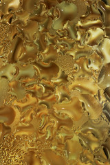 Yellow hot fat droplets deposit on a glass lid