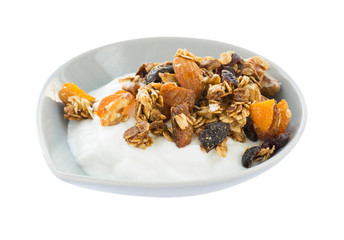 Morning breakfast with greek yogurt and homemade granola isolated on white background. Side view.