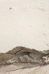 Sand on the beach that has been eroded by ocean waves.
