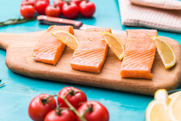 Fresh raw salmon on wooden cutting board.
