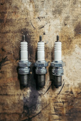 Tree used spark plugs over old wood background