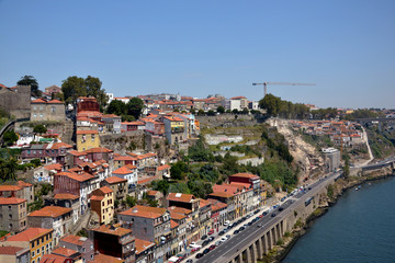 Fototapeta na wymiar Porto, Portugal - August 20, 2015: Cityscape of Porto in summer, with a good weather. This city is built along the river Douro, which goes to the sea.