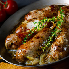 Homemade white sausage fried with onion and herbs