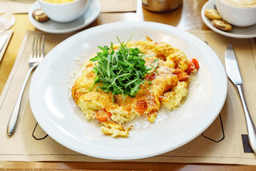 omelet with cherry tomatoes and arugula