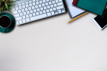 Office equipment with pens, notes, notebooks, tablets, smartphones, mice and coffee mugs placed at the desk.