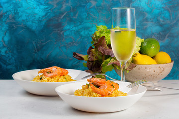 Italian dinner. Prawn risotto with saffron, lemon. Traditional italian dish 