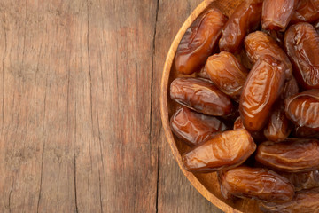 Close up of cluster dates plam. Fresh dates plam on wooden table.