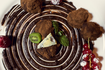 Chocolate truffle sweets with fruit and cheese in a restaurant.