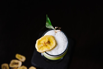 Alcoholic cocktail decorated with banana close-up.