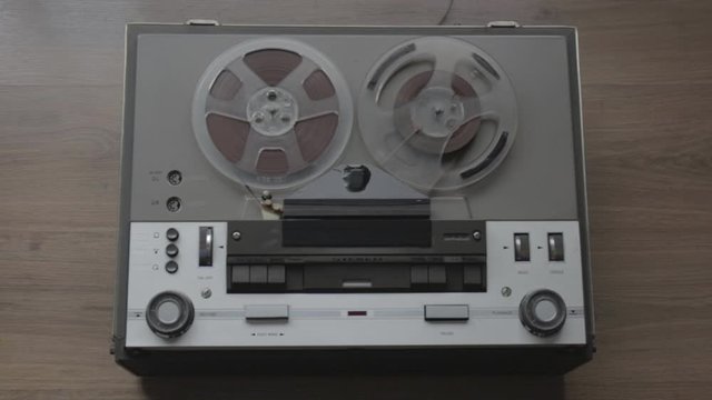 start of old tape recorder, play, pause, rewind. 
Man manipulating