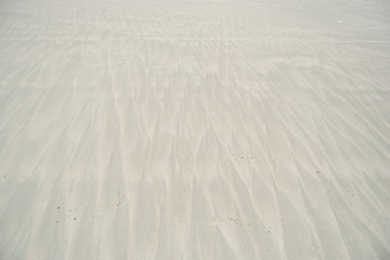 Pattern on the white sand formed by sea water. Doc let beach in Vietnam