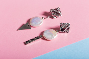 Top view of fashion jewelry and accessories on bright color background. Luxurious jewelry bijouterie and trendy concept.