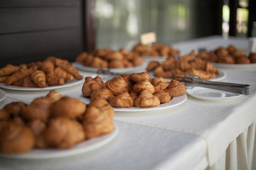 Croissants on a white plate. Catering service concept.