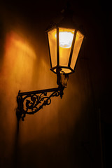 An illuminated wall mounted lamp hanging on the wall.