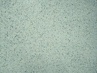 clean cement plaster on wall speckled with various colors as texture or background