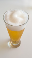 Frosty and detailed beer glass with foam