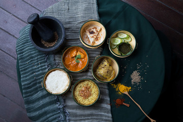 Stylish Indian dishes in pinto lunchbox shot with props