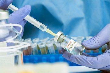 Nurse drawing with a syringe Coronavirus covid-19 experimental vaccine in a hospital, conceptual image