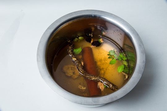 a preparation for a hot cup of ayurvedic medicin called kadha  with lot of herbs for safeguard against corona virus to prevent covid 19, also to prevent cold, cough, infulenza and boost immunity