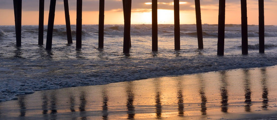 Oceanside Pier reflection on the wet sand at sunset