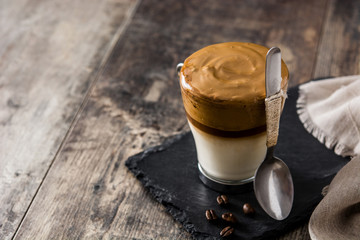 Creamy iced dalgona coffee on wooden table
