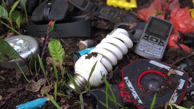 Toxic electronic waste in landfill. E-waste: computers, peripherals, mice, keyboards, and cell phones, batteries, Led lamps, scrap components