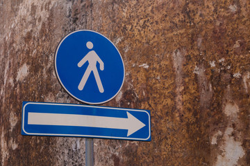 Blue traffic signs: pedestrians and direction