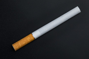 Cigarette on a black background. Close up