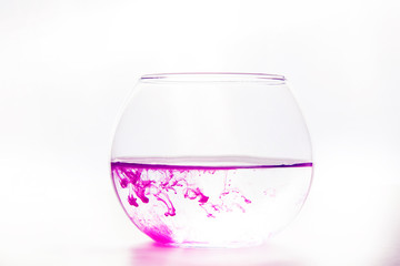 colored water in a glass on a white background. bright colors contrast