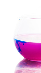 colored water in a glass on a white background. bright colors contrast
