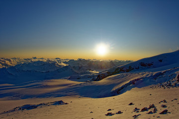 Sunset on Mount Elbrus in summer while climbing.