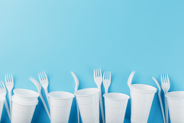 Dishes made of white plastic on a blue background.
