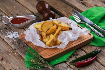 Baked potato wedges with herbs and ketchup decorated with dill.