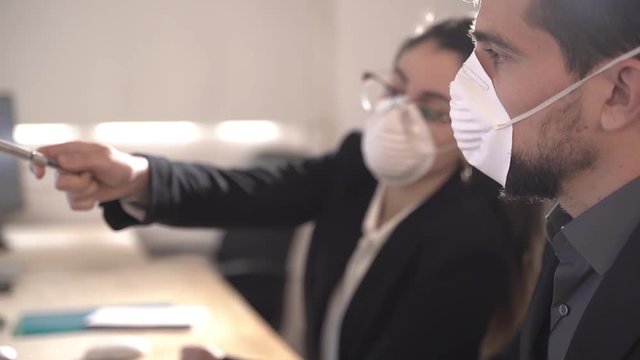 Coronavirus Office workers with mask for corona virus. Business workers wear masks to protect and take care of their health. Office working with computer. Working from home.