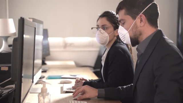 Coronavirus Office workers with mask for corona virus. Business workers wear masks to protect and take care of their health. Office working with computer. Working from home.