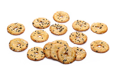 Baked pretzels with black and white sesame seeds, savory snacks isolated on white background