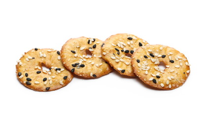Baked pretzels with black and white sesame seeds, savory snacks isolated on white background