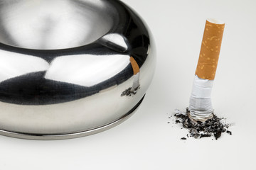 Stubbed cigarette butt stub with ash on white background.