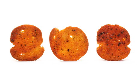 Bruschette chips, grilled bread crisps with tomatoes, olives and oregano, savory snacks isolated on white background