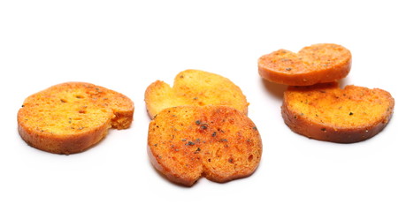 Bruschette chips, grilled bread crisps with tomatoes, olives and oregano, savory snacks isolated on white background