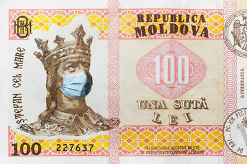Coronavirus in Moldova. 100 Moldavian lei banknote, Stephen the Great wearing medical face mask against covid-19 infection. Financial crisis after pandemic.