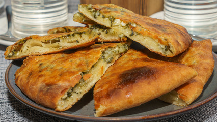 Top view of two Georgian pies. One with cheese, the other with spinach. Traditional Georgian dish khachapuri.