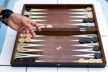 Two friends playing backgammon at home