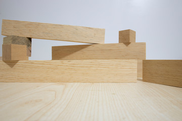 Building from wooden cubes and rods. The photo was taken on the white background and on the table. Close up.