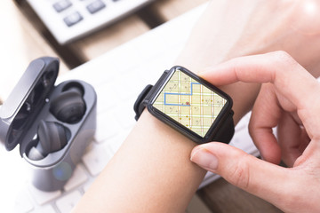 Woman looking at smartwatch map to find address on GPS location services