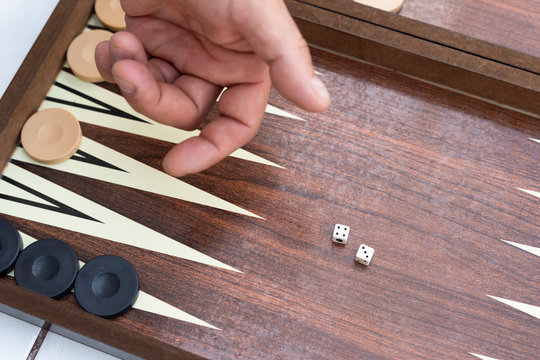 Two friends playing backgammon at home