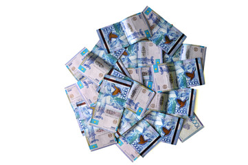 Tenge Kazakhstani money lies in a chaotic heap on a white background